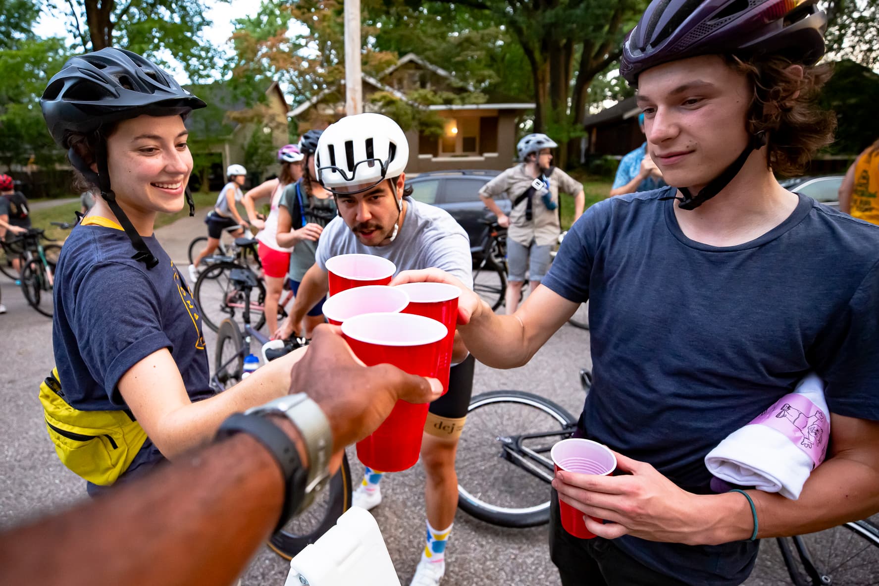 cyclists drinking out of red solo cups